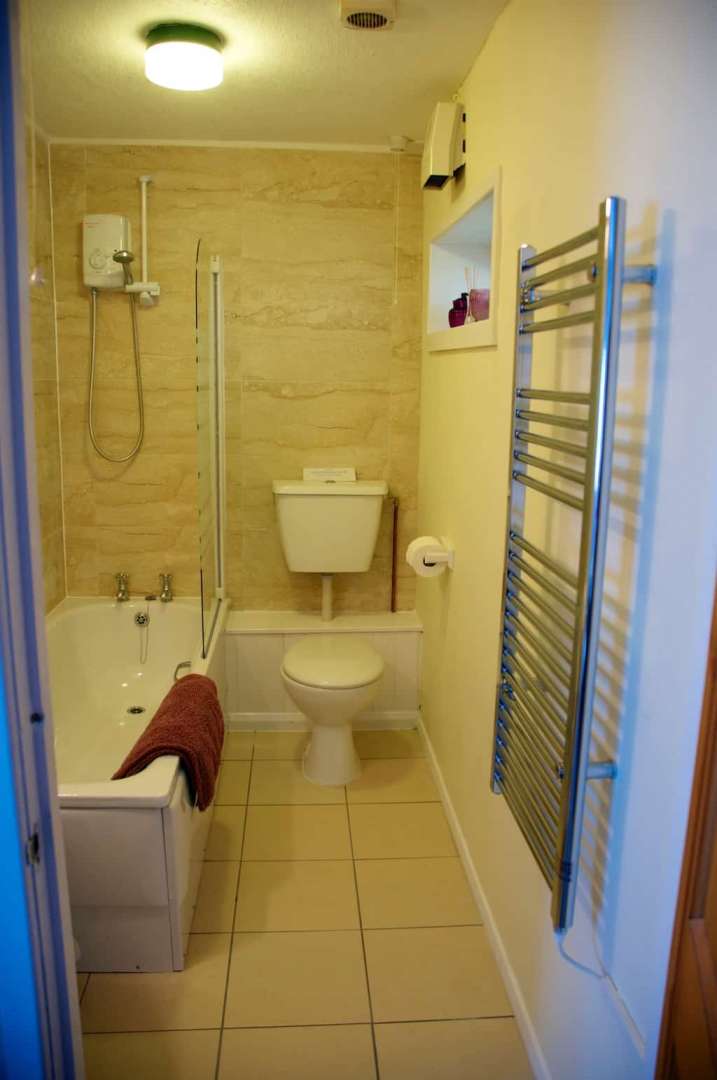 Lake cottage bathroom with electric shower over the bath