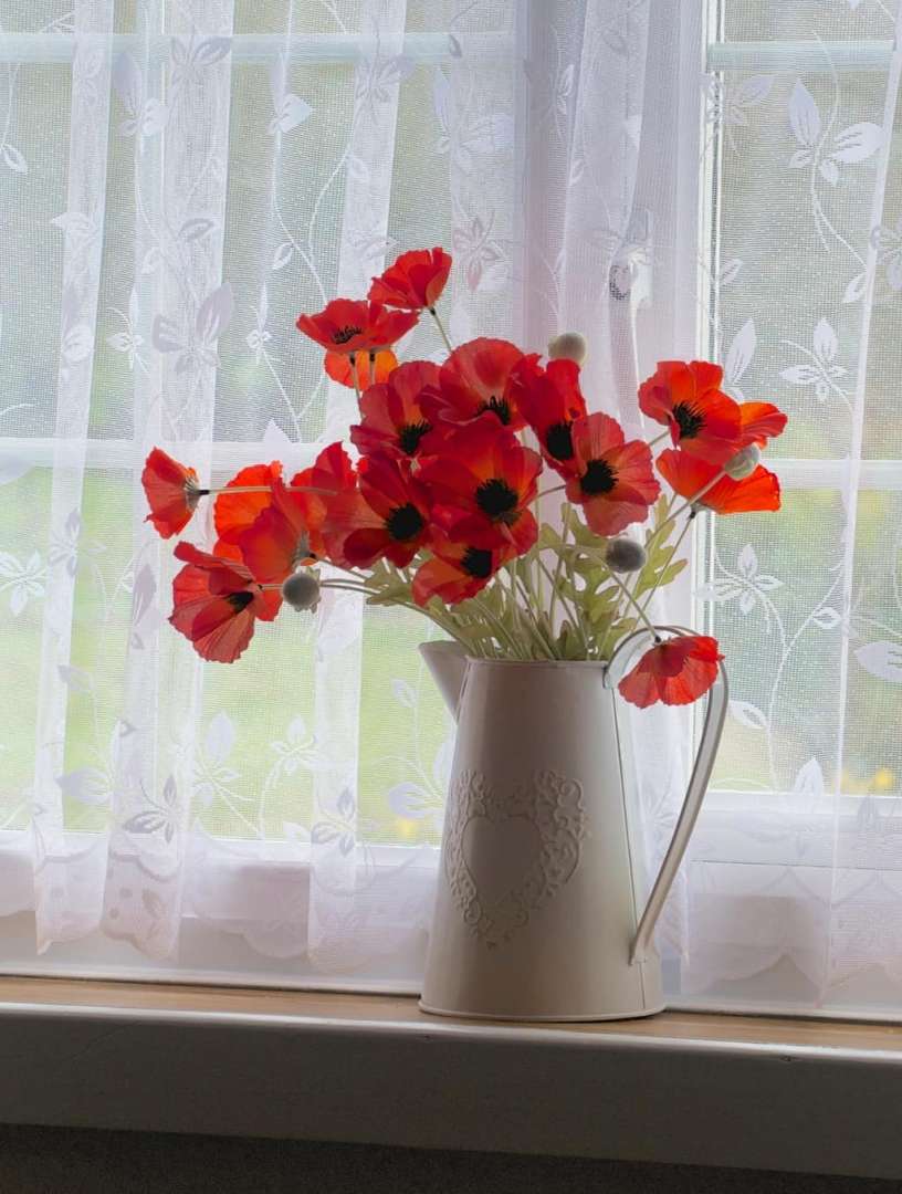 Lake cottage window with poppies