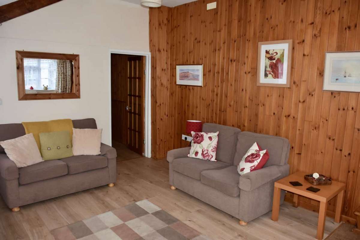 Swallow cottage living room with wooden panelled wall